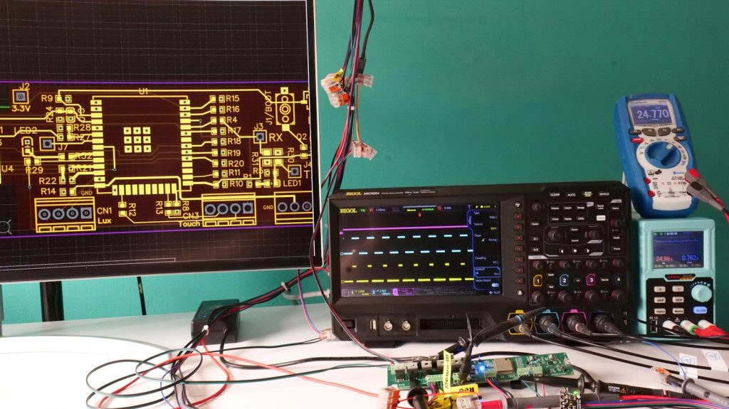 Electronics workbench with oscilloscope and circuit design display; contextual photograph.