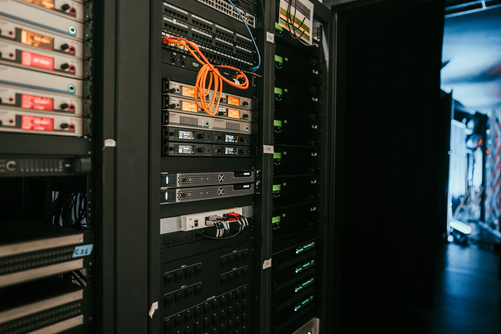 Server and networking hardware in an equipment rack; contextual photograph.